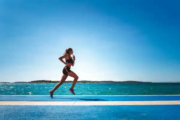Woman running showing strong leg muscle East Retford